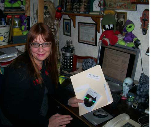 Sue St Clair with copy of The Conspiracy Show 